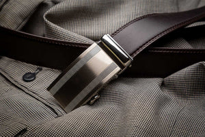 close-up of a black ratchet belt with a silver buckle