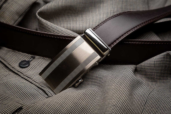close-up of a black ratchet belt with a silver buckle