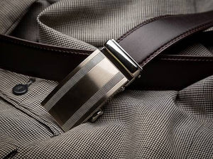 black belt with silver ratchet buckle on dress pants